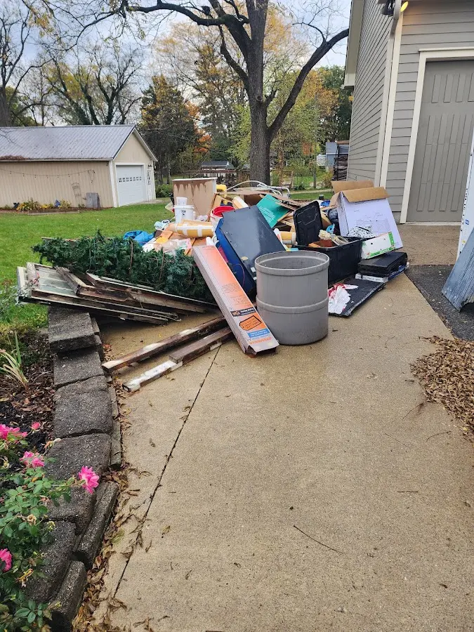 Dumpster being loaded with debris for Estate Cleanout Dumpster Rental in Bonne Terre